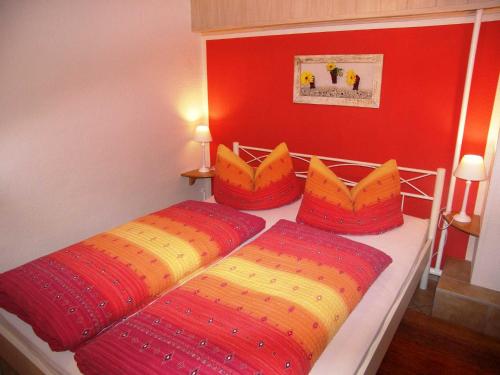 a bedroom with two beds with colorful pillows at Ferienwohnung Krentz in Neu Sallenthin