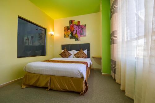 a bedroom with a large bed in a room at Maple Inn Hotel in Nairobi