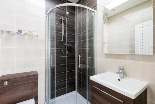 a bathroom with a shower and a sink at The Atholl Palace in Pitlochry