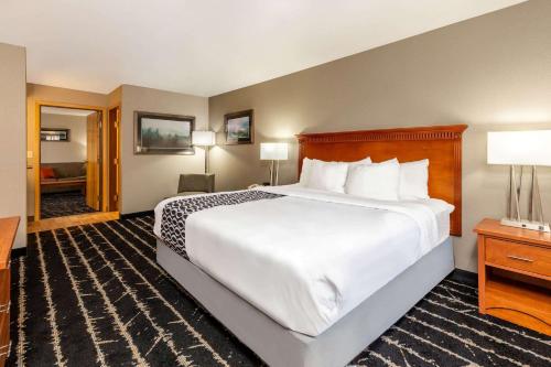 a hotel room with a large bed and a desk at La Quinta by Wyndham Vancouver in Vancouver