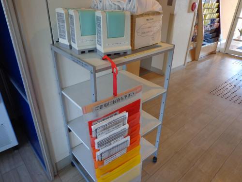 a book cart with three monitors on top of it at Smile Hotel Sendai Izumi IC in Sendai