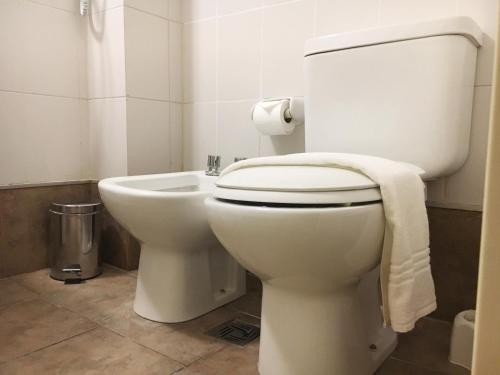 a bathroom with a toilet with a towel on it at Departamentos Lugar in Cordoba