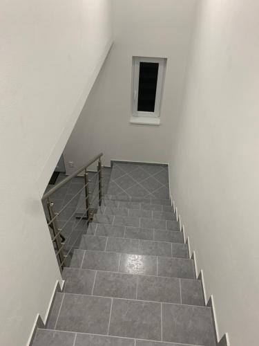 a staircase in a white building with a window at Luxury Private Apartment in Horná Potôň