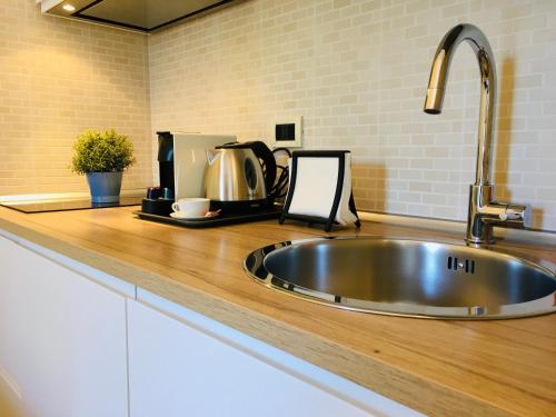 a kitchen counter with a stainless steel sink at Torre Archirafi Vacanze in Riposto
