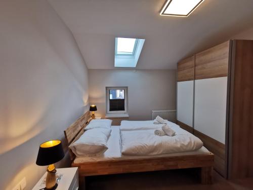 a bedroom with two beds and a skylight at Villa ROWA in Bad Hofgastein