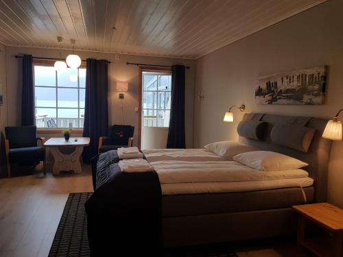 a bedroom with a bed and a table and a window at Flåm Marina in Flåm