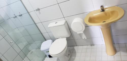 a bathroom with a toilet and a sink at JR Hotel in João Pessoa