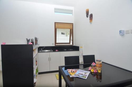 a kitchen with a table with chairs and a counter top at Dream Estate Resort in Senggigi 
