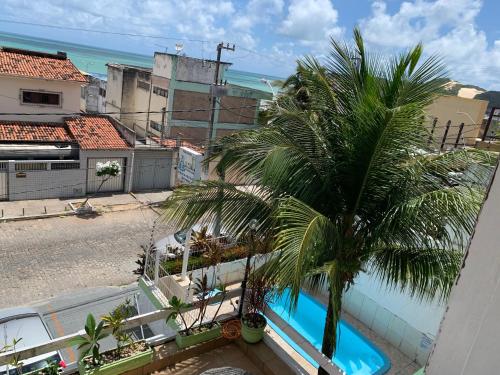 a palm tree on the balcony of a building at Pousada Nossa Natal in Natal