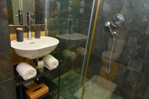 a bathroom with a sink and a shower at My Holiday Home - Aroeira Golf & Beach in Charneca