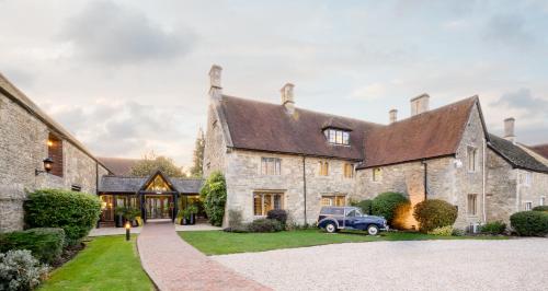 an old car parked in front of a house at voco Oxford Thames by IHG in Oxford