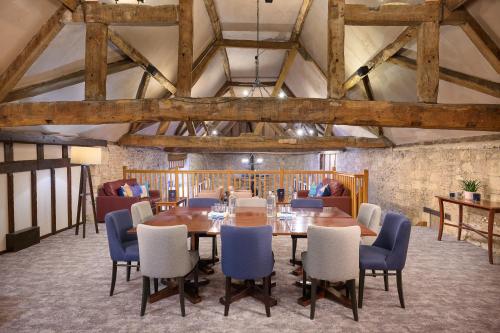 a dining room with a table and chairs at voco Oxford Thames by IHG in Oxford