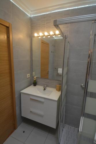 a bathroom with a sink and a mirror at Far-Island Villa in Playa Blanca