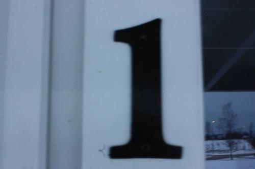 a door with a black number on it at Bedder at Oslo Airport - serviced apartments in Jessheim