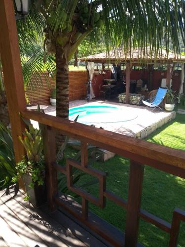 a backyard with a pool and a palm tree at Solar Lisboa 100 m da Praia com vista para mar in Balneário Camboriú