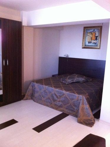a bedroom with a bed in a room at Prestige Hotel in Belene