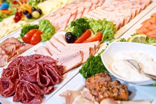 a buffet of different types of meats and vegetables at Park Hotel Laim in Munich