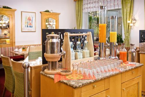 a counter with wine glasses and a blender on it at Park Hotel Laim in Munich