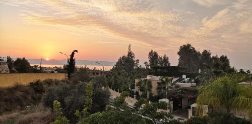 a sunset over a city with trees and buildings at Villa Elena in Argaka in Argaka