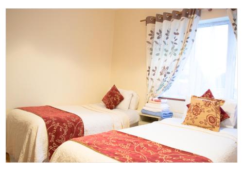 a room with two beds and a window at no 2 Leitrim Road in Carrick on Shannon