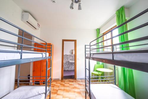 a room with a bunk bed and two bunk beds at Safestay Pisa Hostel in Pisa
