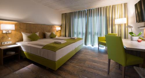 a hotel room with a bed and a desk and a desk at OHO Rooms Herrenberg Digital Access Only in Gäufelden