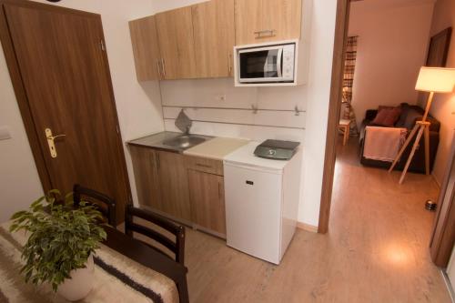 a small kitchen with a sink and a microwave at Apartmány Malý Princ in Bojnice