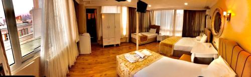 a hotel room with two beds and a balcony at Adora Hotel in Istanbul