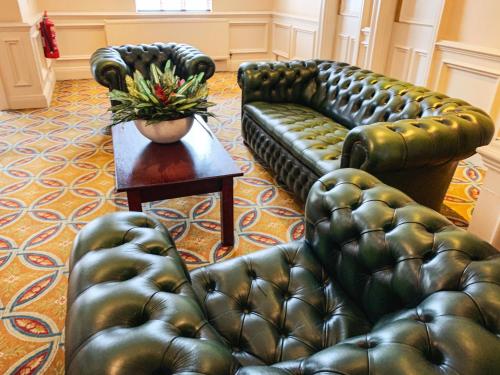 a living room filled with furniture and a couch at Hollins Hall Hotel, Golf & Country Club in Bradford