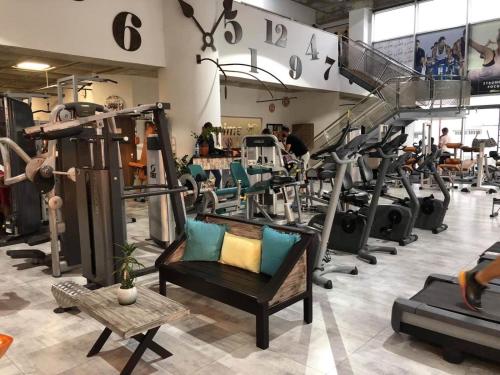 a gym with a bunch of tread machines at Alex Residence in Larnaka
