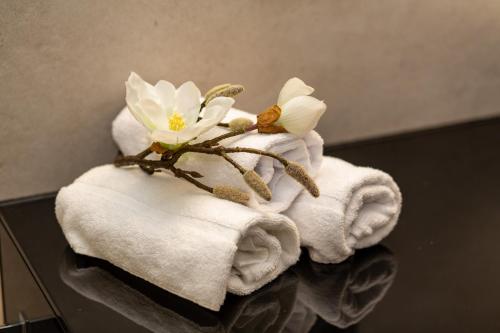 a stack of towels with a flower on top at LUVA Resorts Kappl - Chalet K in Kappl