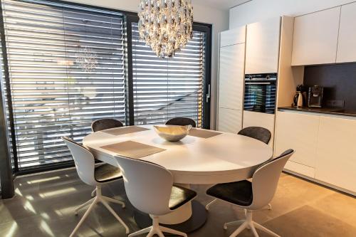 a kitchen and dining room with a table and chairs at LUVA Resorts Kappl - Chalet K in Kappl