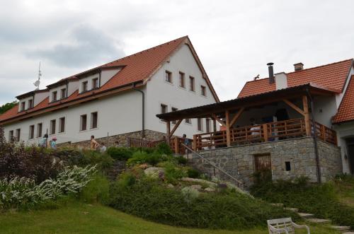 a large white house with a red roof at Hotelový a jezdecký areál Dvůr Krutěnice in Krutěnice