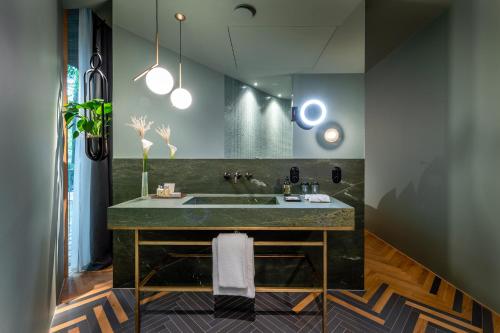 a bathroom with a sink in a room at LA MAISON hotel & spa in Saarlouis