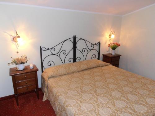 a bedroom with a large bed and two night stands at Hotel Garnì Bartabel in Gargnano