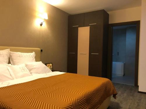 a bedroom with a bed with a black cabinet at Silver Mountain G1 15 in Poiana Brasov