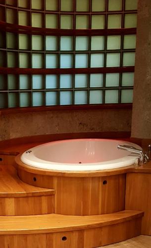 a bath tub in a bathroom with a window at Studio 4 in Warsaw