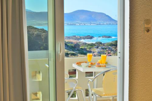 a room with a table with a view of the ocean at Falasarna Bay in Falasarna