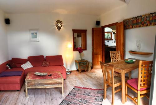 a living room with a red couch and a table at Casa Mia in Valle Gran Rey