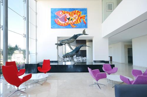 a dining room with red and purple chairs at Holiday Inn Express Puerto Vallarta by IHG in Puerto Vallarta