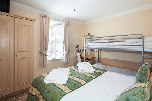a bedroom with two bunk beds and a window at Burbage Holiday Lodge Apartment 5 in Blackpool
