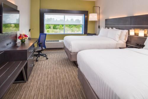 a hotel room with two beds and a desk at Holiday Inn Express & Suites - Tampa North - Wesley Chapel by IHG in Wesley Chapel