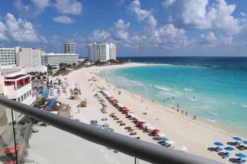 a view of a beach with umbrellas and the ocean at Oceanside Studio - Stunning Views, Ideal Location in Cancún