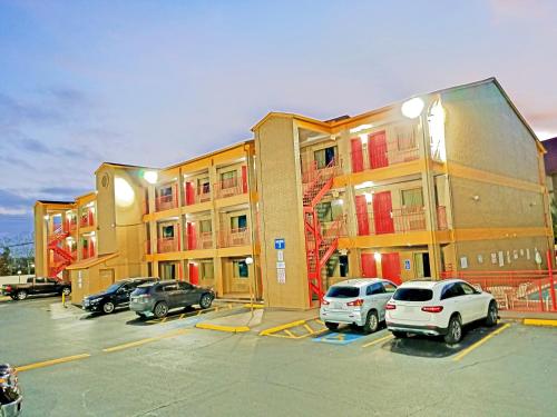 a parking lot with cars parked in front of a building at Howard Johnson by Wyndham Houston Hobby Airport in Houston