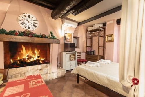 a living room with a fireplace and a clock on the wall at Casetta Di Carlo Magno in Sutri