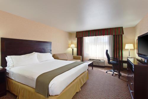 a hotel room with a large bed and a television at Holiday Inn Express Temecula by IHG in Temecula