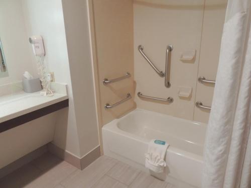 a white bathroom with a tub and a sink at Holiday Inn Express Trussville by IHG in Trussville