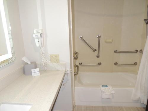 a bathroom with a shower and a bath tub with a phone at Holiday Inn Express Trussville by IHG in Trussville