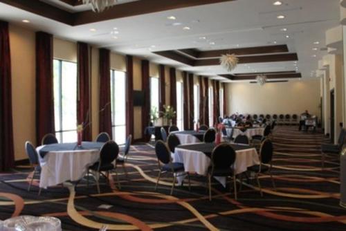 a banquet hall with tables and chairs in a building at Holiday Inn Vicksburg, an IHG Hotel in Vicksburg