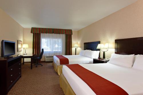 a hotel room with two beds and a flat screen tv at Holiday Inn Express Temecula by IHG in Temecula